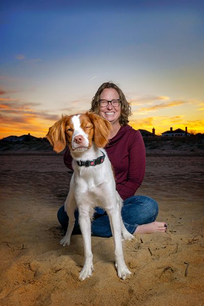 A Brittany Spaniel winks at the camera. Virginia Beach north end