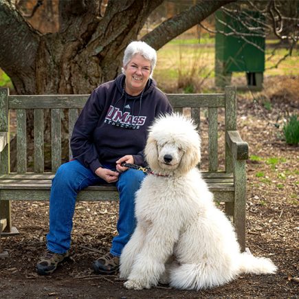 Barb Hays, Windhound Photographer, poses on a bench with her poodle, Blaze, at the Norfolk Botanical Garden.